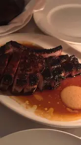 A montage of food and drink dishes at Vesper restaurant, showcasing the intimate, candlelit atmosphere and the menu offerings.