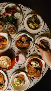 A behind-the-scenes look at a professional food photography shoot at Hatch Brunch House, featuring the setup process and the resulting high-quality images of various brunch dishes and drinks.