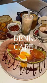 A short review video of Benk Café in Birmingham, featuring close-up shots of brunch dishes including smoked salmon toast, shakshuka, and a full English breakfast, accompanied by coffee. The video uses text overlays to provide an honest review of the food quality and pricing.