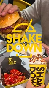 A short, energetic review of a burger restaurant called Shakedown in Edinburgh, highlighting their burgers, loaded fries, and milkshakes. The creator provides a personal recommendation, noting the affordability and quality of the food, while also showing the venue's interior and ordering process.