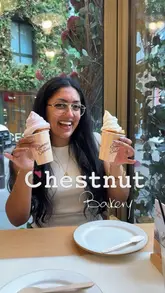 A creator visits Chestnut Bakery to review their new summer menu, featuring pastries, flatbreads, iced drinks, and a unique soft-serve croissant dessert. The video includes a tour of the Covent Garden branch.