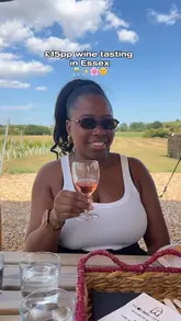 A bright and inviting shot of a woman enjoying a wine tasting experience at a vineyard in Essex. The image effectively captures the relaxed, sunny atmosphere of the venue, making it look like an appealing destination for a day out.