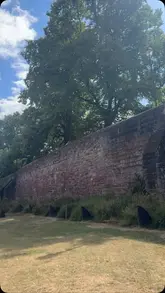 A couple spends a day in Chester, starting with a walk by the racecourse, followed by a lunch at Artezzan restaurant, and ending with a stroll along the historic city walls and the River Dee.