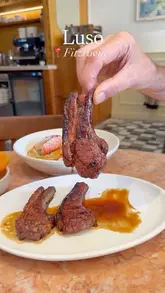A montage of various Portuguese dishes served at Luso in Fitzrovia, featuring close-up shots of lamb chops, scallops, sardines, prawns, lobster rice, and a traditional sponge cake.