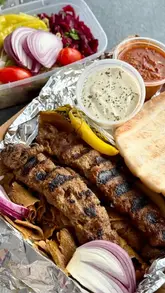A montage of takeaway food items including kebabs, pizzas, and desserts, presented in their takeaway packaging.