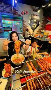 A family-focused vlog showcasing a visit to Belt Noodles in London, highlighting their signature wide belt noodles and grilled skewers.
