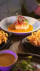 A montage video showcasing the interior, menu, and various dishes at The Brook Bistro, including steak, fish, and dessert, highlighting its suitability for families and date nights.