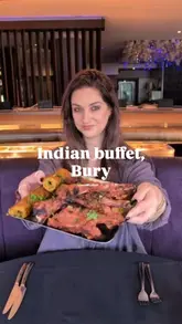 A video review of the buffet at Indigo, an Indian restaurant in Bury. The creator shares their personal history with the venue, highlights the buffet pricing, and samples various dishes from the Indian and international buffet sections, including lamb chops, butter chicken, and keema.