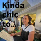 A candid, evening shot of a woman holding a cocktail menu at an outdoor table, used as the cover image for a listicle highlighting various hospitality venues in Chester.