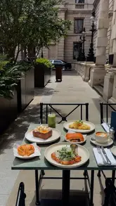 A short, aesthetic montage showcasing brunch dishes and the outdoor courtyard setting of Cafe Ciel at The OWO London.