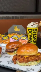 A promotional video for Shakedown in Edinburgh, showcasing their range of burgers, loaded fries, milkshakes, and desserts. The video features close-up shots of the food being held and prepared, alongside brief glimpses of the venue's interior and exterior.