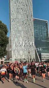 A bright, high-quality shot of a large group of people running together in Canary Wharf, London, promoting a local run club. The image captures a sense of community and active lifestyle against the backdrop of the city skyline.