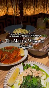 A short, music-led montage showcasing the interior and various dishes at The Meat & Wine Co in Mayfair, including steak, sides, and desserts.