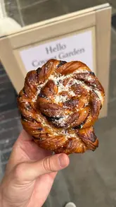 A promotional video for the new Sourdough Sophia bakery location in Covent Garden, featuring close-ups of various pastries, open sandwiches, and specialty lattes, alongside shots of the shop interior and exterior.