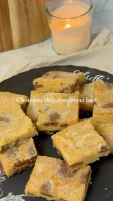 A step-by-step recipe video demonstrating how to make chocolate chip shortbread bars at home, featuring clear shots of the ingredients and mixing process.