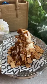 A visually appealing montage showcasing brunch dishes, iced lattes, and a decadent dessert at EL&N, featuring close-ups of pasta, corn ribs, and a cookie sundae.
