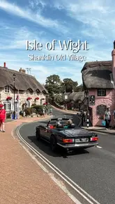 A travel-focused reel showcasing the picturesque Shanklin Old Village on the Isle of Wight, featuring a vintage car driving through the historic street lined with thatched cottages.