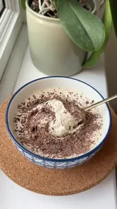 A short, top-down recipe tutorial demonstrating how to make 'cake batter oats' by blending ingredients and mixing them with Greek yogurt and protein powder.