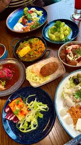 A montage showcasing the dining experience at La Fiesta in Leeds, highlighting the unlimited small plates concept, the salad bar, and the variety of dishes available.
