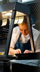 A chef at Myrtle restaurant discusses the importance of integrity and 'heartbeat' in dish creation, interspersed with shots of intricate plating and service in a fine dining setting.