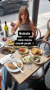 A creator reviews the new set menu at Bubala Spitalfields, showcasing a wide variety of vegetarian Middle Eastern dishes, including hummus, baba ganoush, skewers, and cauliflower shawarma.