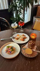 A visually appealing reel showcasing a dinner experience at Nessa in Soho, featuring a variety of small plates, main courses, cocktails, and dessert in a stylish, well-lit setting.