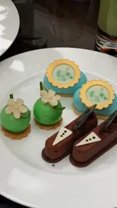 A high-quality vlog showcasing a Bridgerton-themed afternoon tea experience at The Lanesborough hotel in London. The video highlights the elegant venue, the themed tea service, and close-ups of the sandwiches, scones, and intricate pastries.