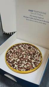 A short, simple product unboxing video featuring two cakes from Kake Temptations, focusing on the packaging and the appearance of the desserts.