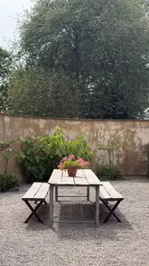 A short, aesthetic montage showcasing a pop-up cafe in a garden setting, featuring iced coffees, pastries, and outdoor seating.
