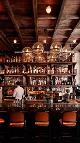 A montage of high-quality shots featuring the interior of Wild restaurant, including close-ups of wine, grilled prawns, steak, and tiramisu, set to music.