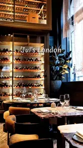 A short, polished montage showcasing the interior, wine cellar, and several plated dishes at Jul's London, highlighting the fine dining experience.
