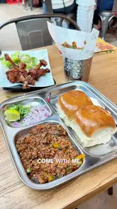A creator visits Chit 'n' Chaat in the Trafford Centre, showcasing the vibrant interior and a variety of Indian street food dishes including chicken kati roll, okra fries, samosa chaat, chicken lollipop, keema pav, and chicken momos.