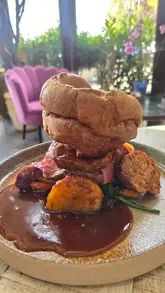 A montage video showcasing a visit to Dunston Hall Food Hall & Bistro, highlighting the exterior, the bistro dining area, a Sunday roast, and the deli/retail section of the food hall.