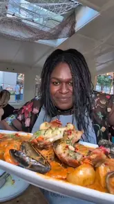 A video review of a seafood restaurant located on a boat in Paddington, London. The creator visits with family, showcasing the venue's unique setting, the seafood boil, oysters, and other dishes.