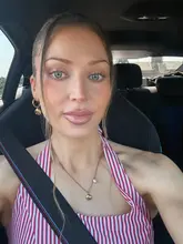 A selfie of a woman in a car, captioned as being for a dinner date. The image focuses entirely on the individual rather than the hospitality venue.