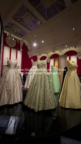 A montage of shots showcasing the Queen Elizabeth II: Her Life in Style exhibition at The King's Gallery, Buckingham Palace, featuring various outfits, hats, and accessories worn by the late monarch.