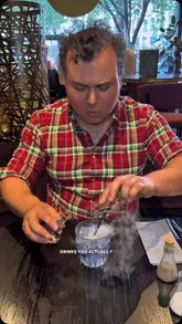 A video showcasing a visit to The Alchemist, highlighting their theatrical cocktails and food offerings.