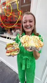 A promotional reel for It's Bagels in Soho, highlighting their new Bodega Nights late-night menu available Thursday through Saturday. The video features the creator trying various items, including a chopped cheese bagel, a Reuben, a sausage egg and cheese bagel, and a cookie monster dessert, while showcasing the venue's New York-inspired atmosphere and film screenings.