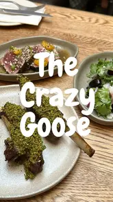 A creator visits The Crazy Goose in Brighton to review their new Mediterranean-inspired small plates menu. The video features a variety of dishes including flatbread, hummus, pickled cucumber, tuna crudo, sea bream ceviche, lamb ribs, chicken skewers, and a pistachio soft serve dessert, alongside a spicy margarita. The creator provides commentary on the quality of the food and the overall dining experience.