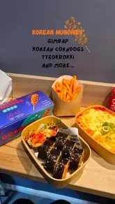 A review of Korean Munchies in Edinburgh, featuring a variety of Korean street food dishes including corn dogs, gimbap, tteokbokki, and fried chicken. The creator highlights the quality of the food, specifically the cheese pull on the corn dog and the flavour of the gimbap.