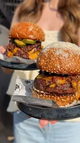 A review video featuring a creator visiting Black Cactus BBQ to test their burger menu. The video includes shots of the food, the kitchen preparation process, and the creator's reaction to the meal.