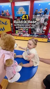 A parent documents the process of taking their child to a Build-a-Bear workshop to redeem the 'pay your age' birthday offer. The video walks through selecting the bear, the stuffing process, dressing the bear, and registering the birth certificate, providing a clear guide for other parents.