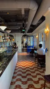 A short, aesthetic montage showcasing the interior, coffee, and pastries of Cafe 1922 in Chelsea, highlighting its continental cafe vibe.
