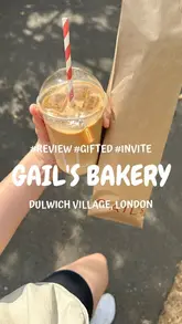 The video begins with a first-person POV of a bike ride to pick up a loaf of bread from GAIL's Bakery. It then transitions to a home setting where the creator slices the bread and assembles avocado toast topped with tomato and chilli jam and salt.