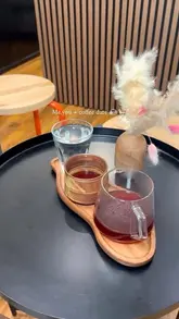 A short, aesthetic montage showcasing a visit to MuKafe Studio, a cat-themed specialty coffee shop in Manchester. The video features shots of the coffee service, the interior decor, the menu board, and the exterior signage.