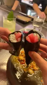 A short video showcasing a Japanese hand roll sushi bar in Soho, featuring close-ups of sushi preparation, crudo dishes, and the counter dining experience.