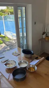 A chef demonstrates the process of making a burnt Basque-style cheesecake in a home kitchen setting.