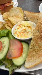 A video tour of Three Cliffs Coffee Shop in Gower, showcasing the outdoor and indoor seating, the menu, the retail shop, and the food offerings like toasties and homemade cakes.