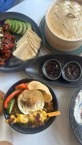 A montage of various Asian fusion dishes, cocktails, and the interior of East Lane restaurant in Kingston, featuring close-ups of food being served and enjoyed.