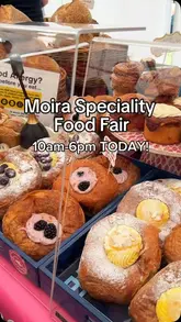 A montage video showcasing the Moira Speciality Food Fair, featuring various stalls including pastries, local produce, charcuterie, hot sauces, cupcakes, fresh flowers, crafts, kitchen demonstrations, food trucks, and live music.